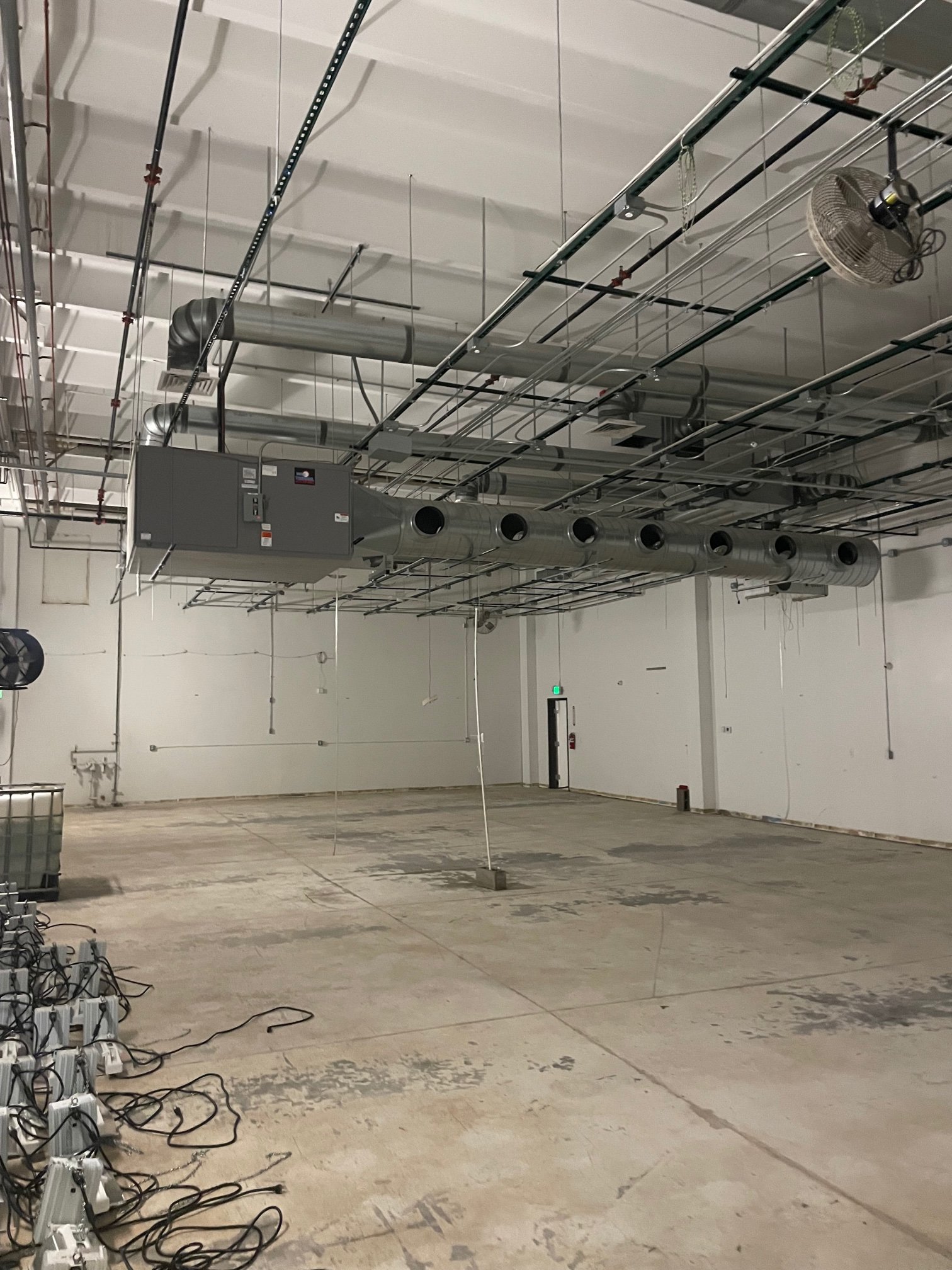 Grow room with HVAC ducting and circulation fans installed