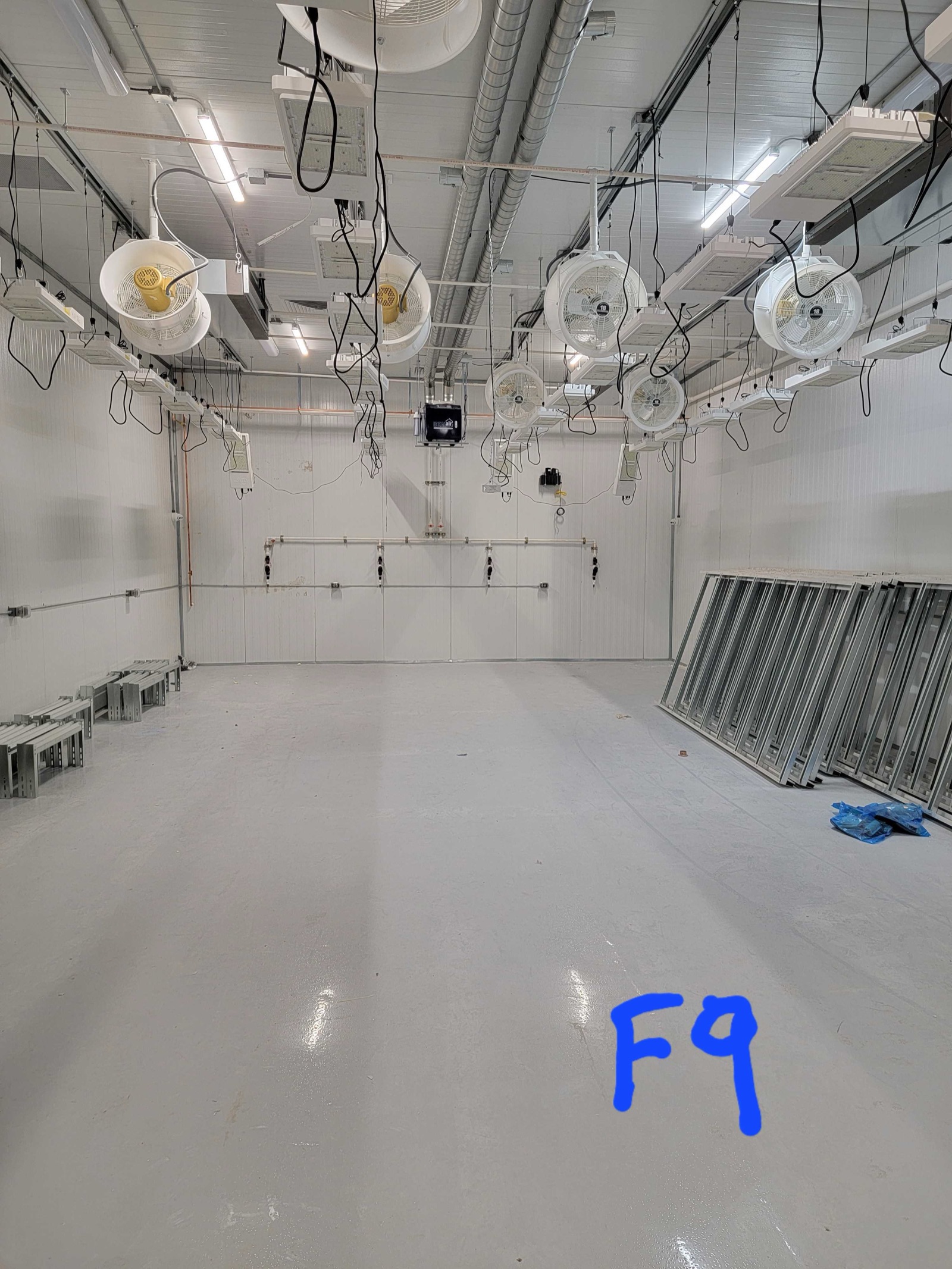 Grow room with LED lighting and circulation fans installed overhead