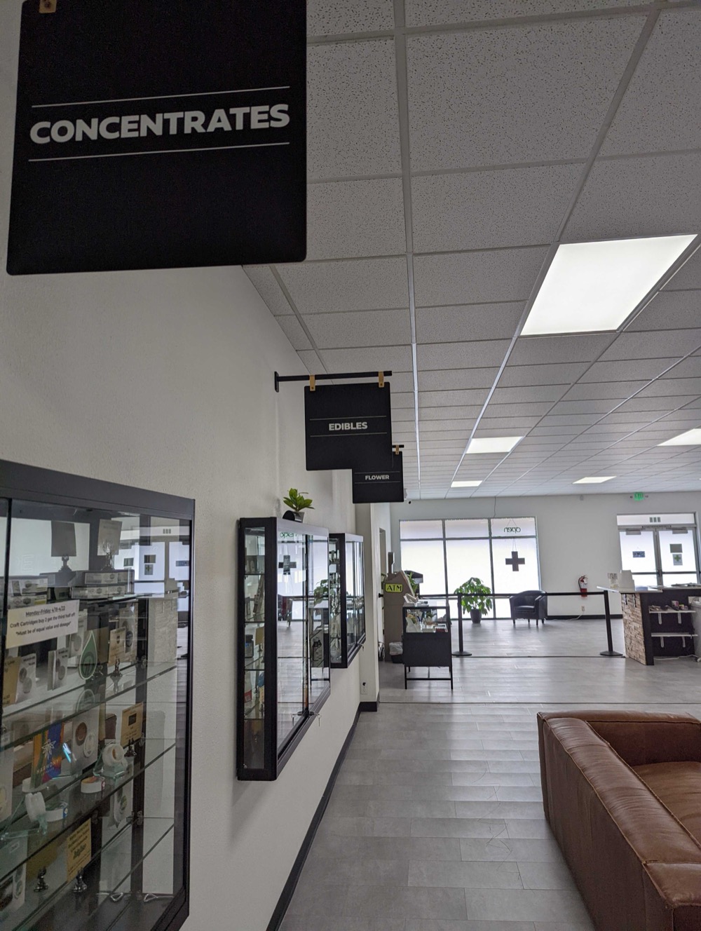 Sales floor with category signage, display cases, and lounge seating