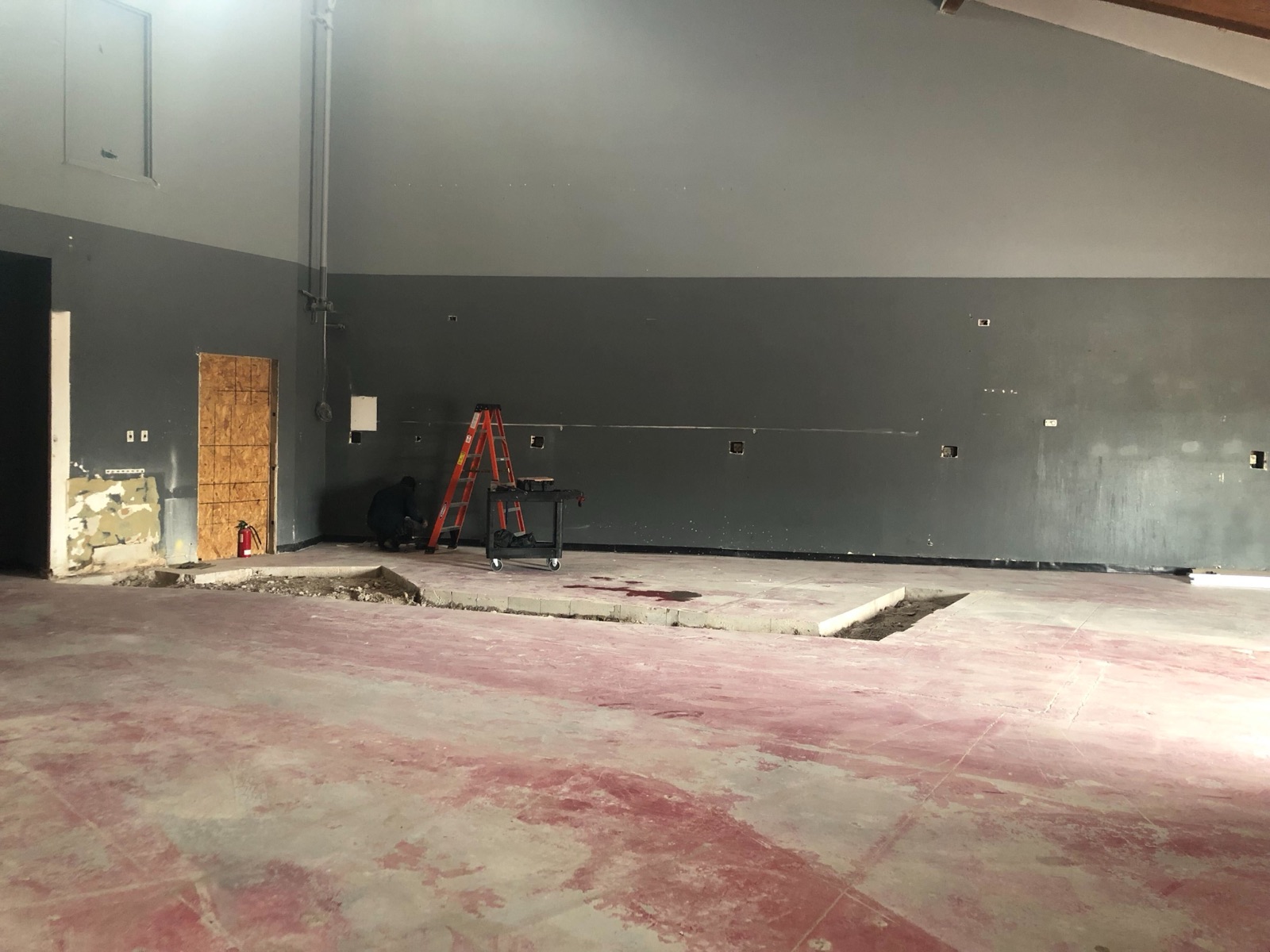 Drywall installed on the sales floor with rough electrical marked out